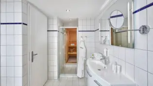 Bathroom with sauna in the apartment - H+ Hotel Ferienpark Usedom - Official website